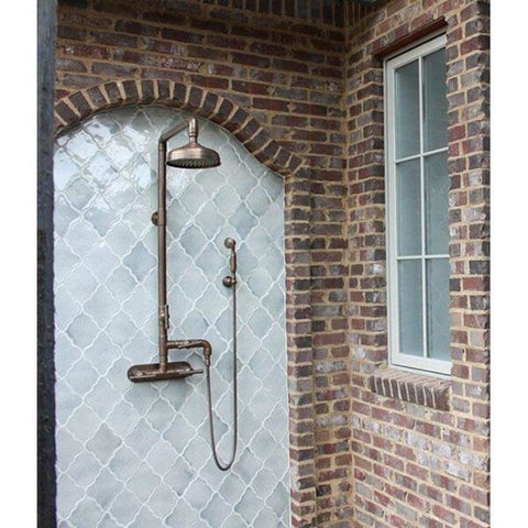 Outdoor shower with tiled wall and brick archway