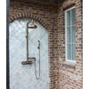 Outdoor shower with tiled wall and brick archway